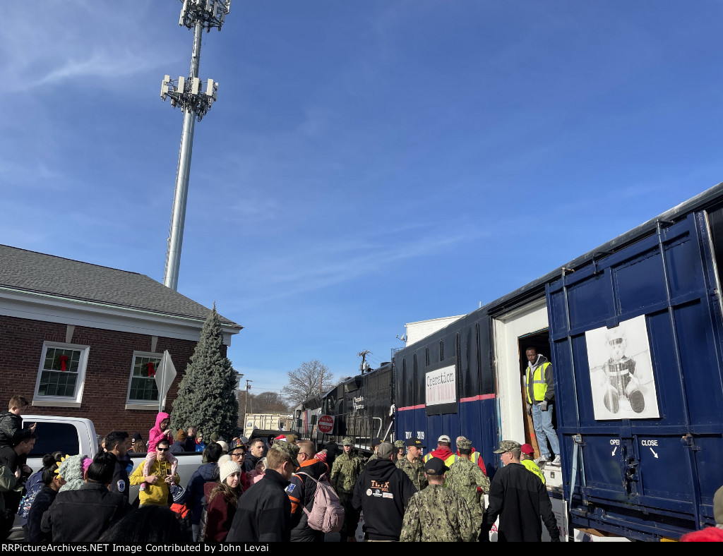 So many people gather around the train giving gifts as the train blocks Sussex St in Downtown Dover 